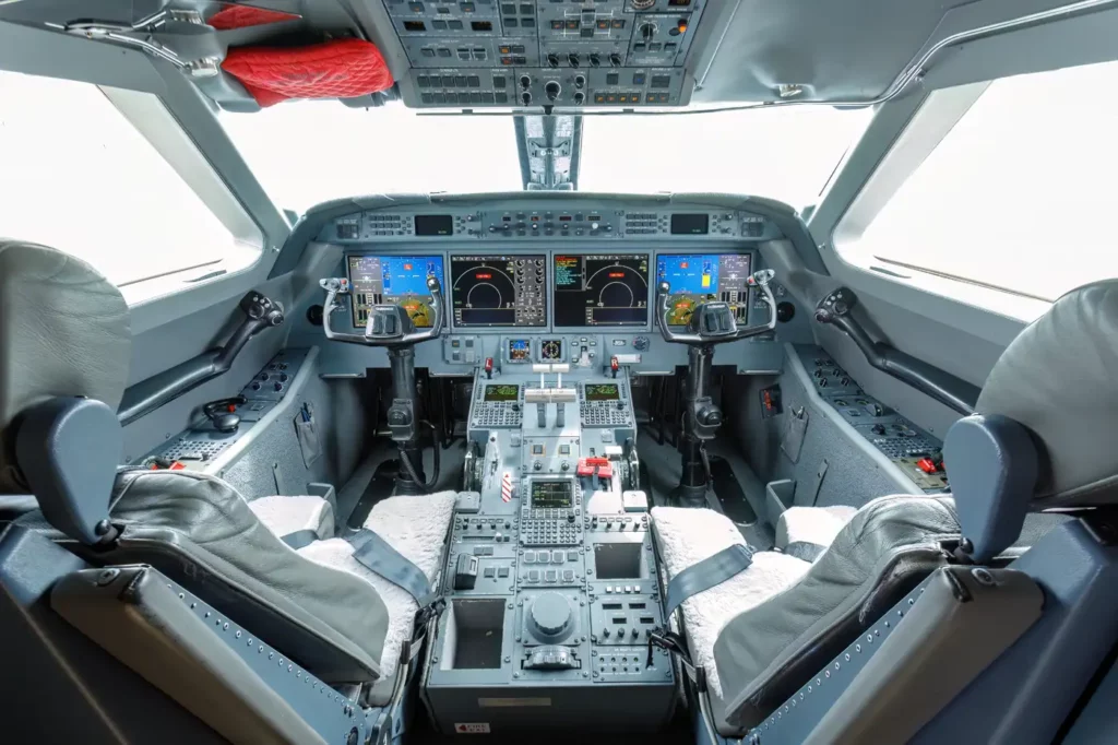 Cockpit of the Gulfstream G550, equipped with advanced avionics and multiple digital displays, showcasing the pilot and co-pilot seats.