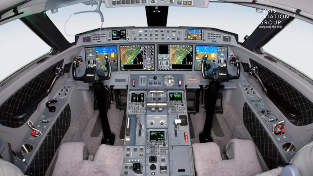 Cockpit of a Gulfstream G650 jet, featuring a state-of-the-art flight deck with multiple digital screens displaying navigation and flight information. The cockpit is equipped with advanced controls, including dual yokes, throttle levers, and a variety of switches and instruments, all designed for optimal pilot functionality.