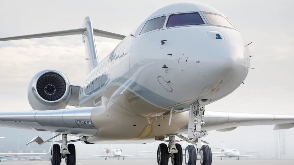 Front side view of a Bombardier Global 5000 jet parked on the tarmac, ready for boarding.