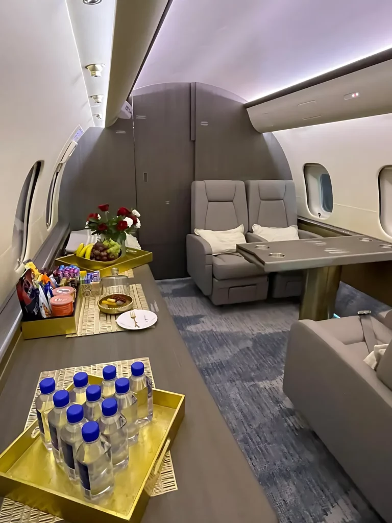 Forward cabin seating area of the Bombardier Global 5000 jet with spacious and comfortable seats.