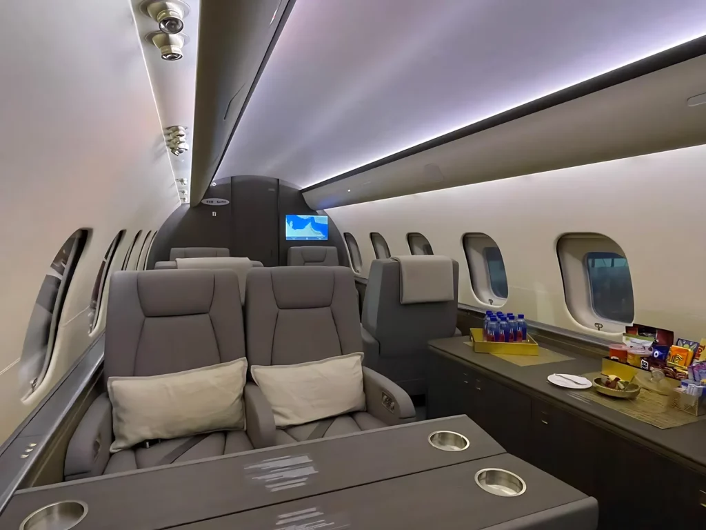 Forward executive cabin of the Bombardier Global 5000 jet, showcasing luxurious seating arrangements and a sleek interior.