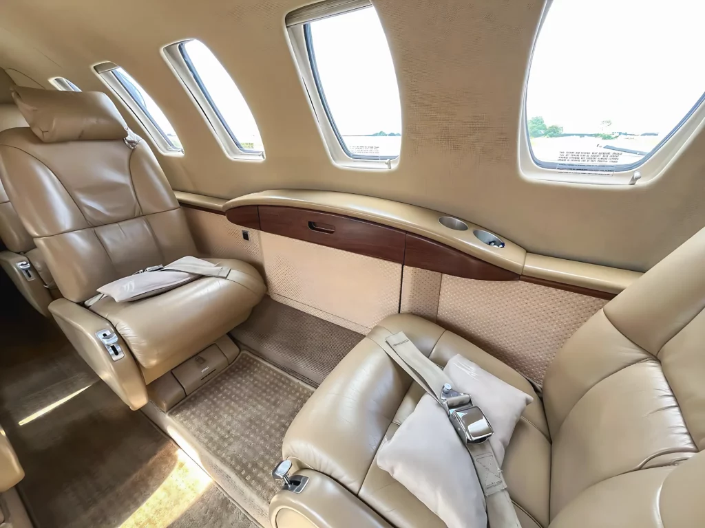 Interior view of a Cessna Citation CJ2 showing comfortable seating and large windows.