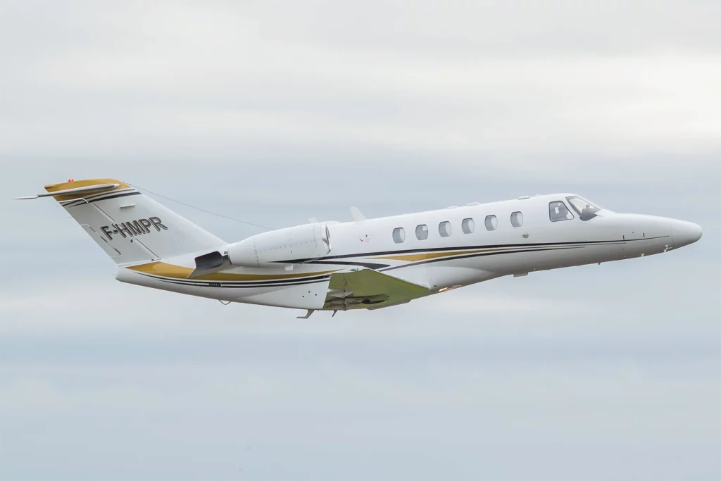 Cessna Citation CJ2 in flight against a cloudy sky.