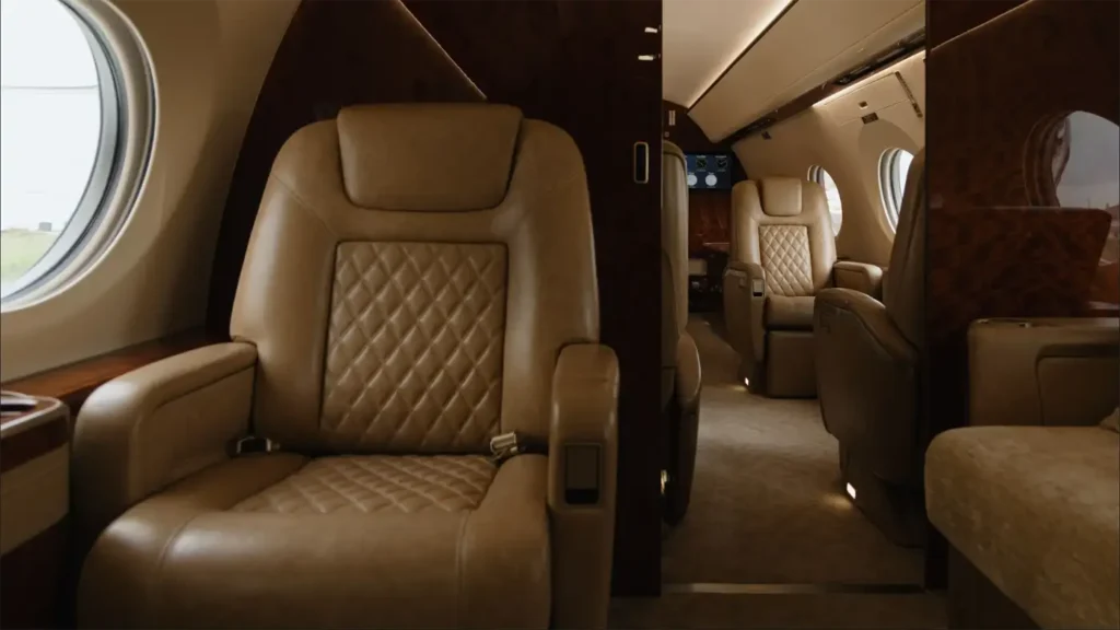 Luxurious Gulfstream G500 cabin featuring tan leather seats with quilted design and large oval windows