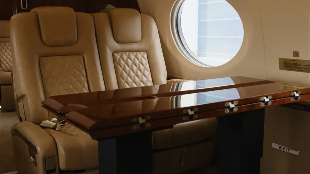 Gulfstream G500 cabin interior with leather seats and a polished wood table, offering comfort and style