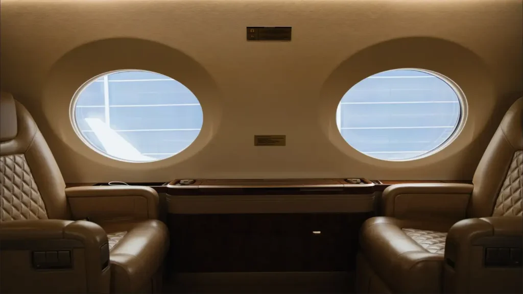 Gulfstream G500 cabin interior with plush leather seats and large round windows, offering luxurious comfort