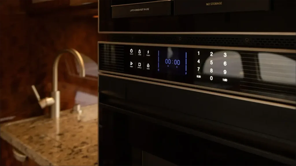 Gulfstream G500’s galley area with microwave and sleek kitchen appliances, highlighting the high-end design