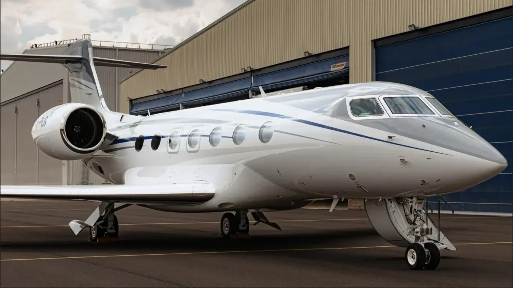 Close-up of Gulfstream G500 private jet parked outside a hangar, emphasizing its aerodynamic structure and powerful engine