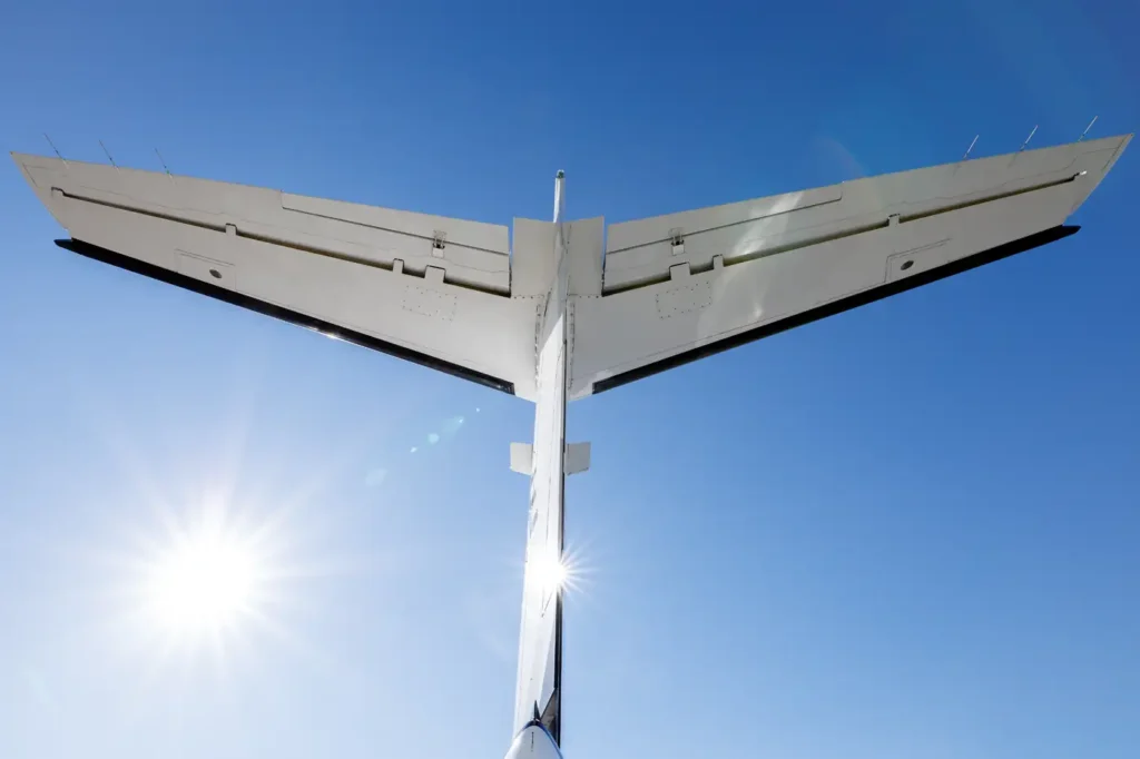 Rear view of Cessna Citation CJ3 tail with bright sun against clear blue sky