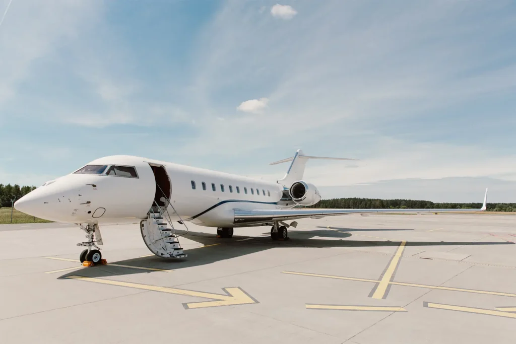 bombardier global 5000 sitting on tarmac runway with entrance stairs down serial number 9H-ONE