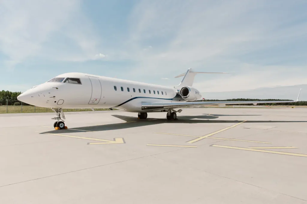 Front view of Bombardier Global 5000 private jet on the runway, showcasing its nose and front landing gear