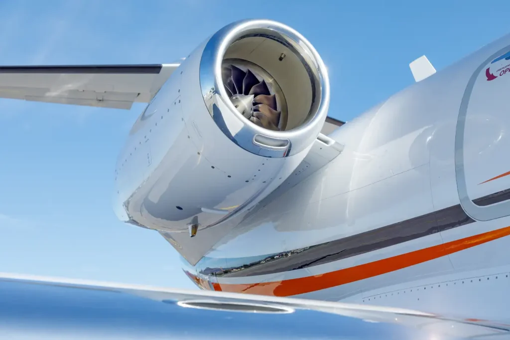 Cessna Citation CJ3 landing gear and wing with shiny surface on a runway