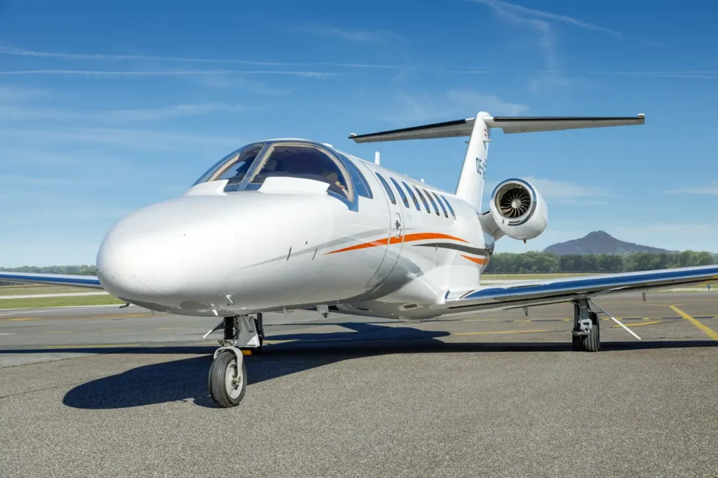 Close-up view of Cessna Citation CJ3 private jet OE-GIE parked on the runway