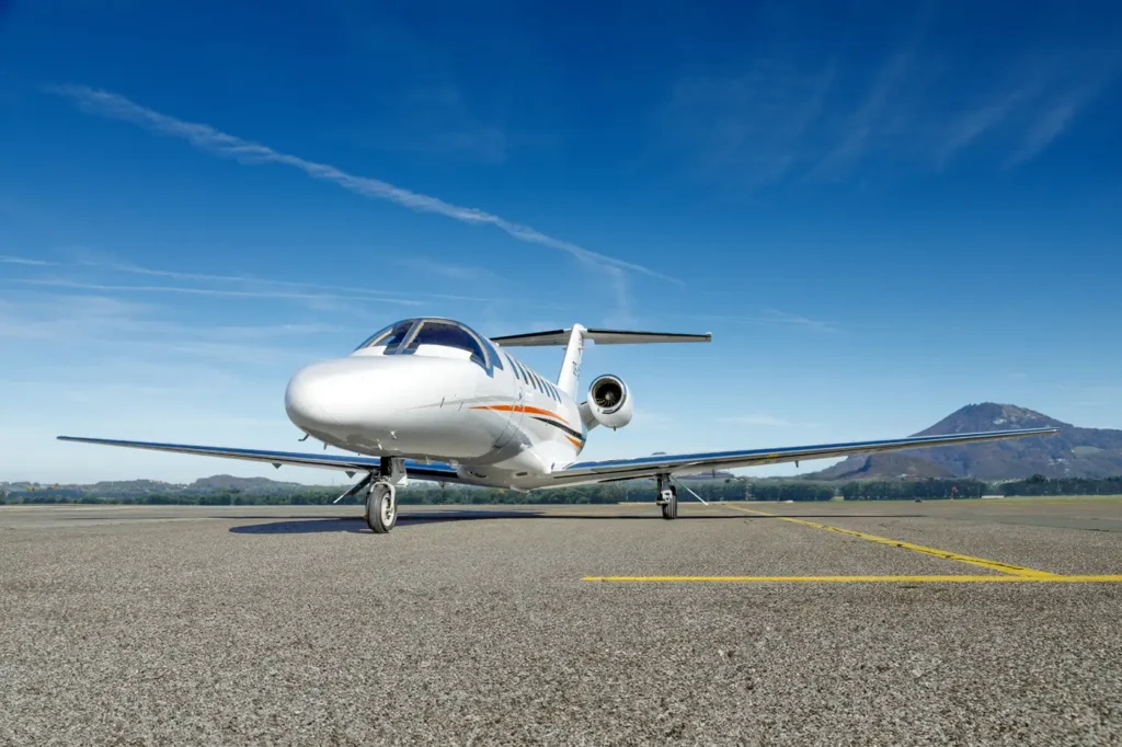 Cessna Citation CJ3 private jet OE-GIE parked on tarmac under clear blue sky