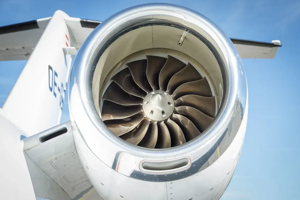 Close-up of Cessna Citation CJ3 engine turbine blades with tail wing in background