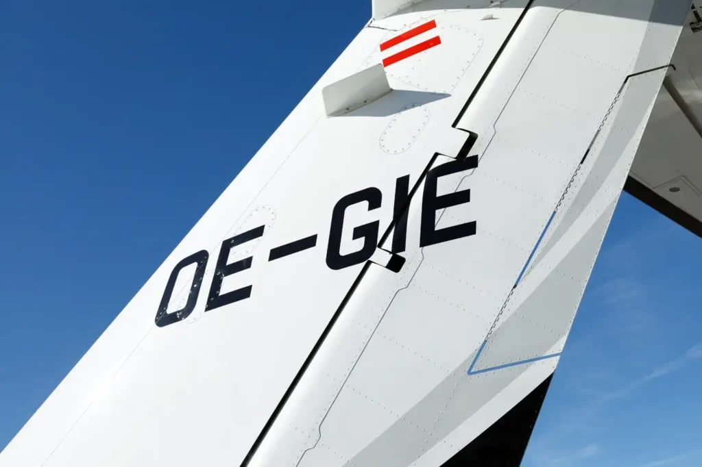 Cessna Citation CJ3 tail displaying registration number 'OE-GIE' under clear blue sky