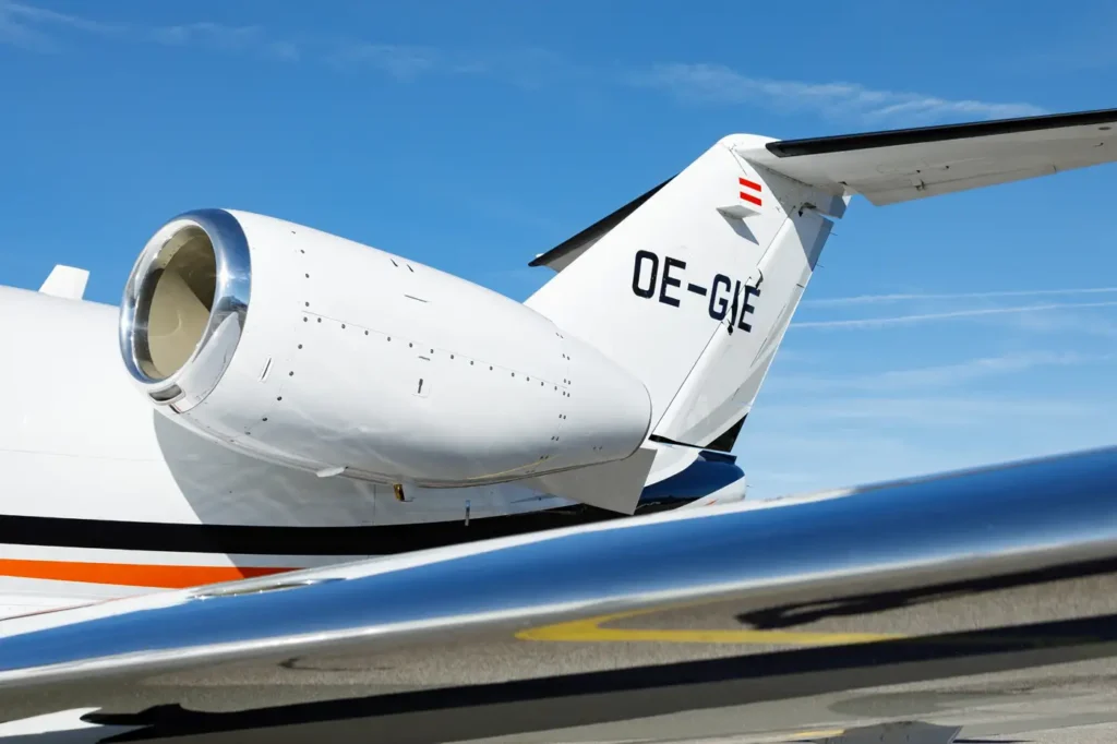 Cessna Citation CJ3 private jet engine close-up with registration OE-GIE on tail parked on the tarmac